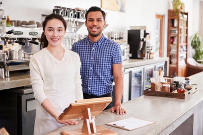 mixed-race-couple-behind-the-counter-at-their-coff-2024-10-19-08-00-55-utc-low